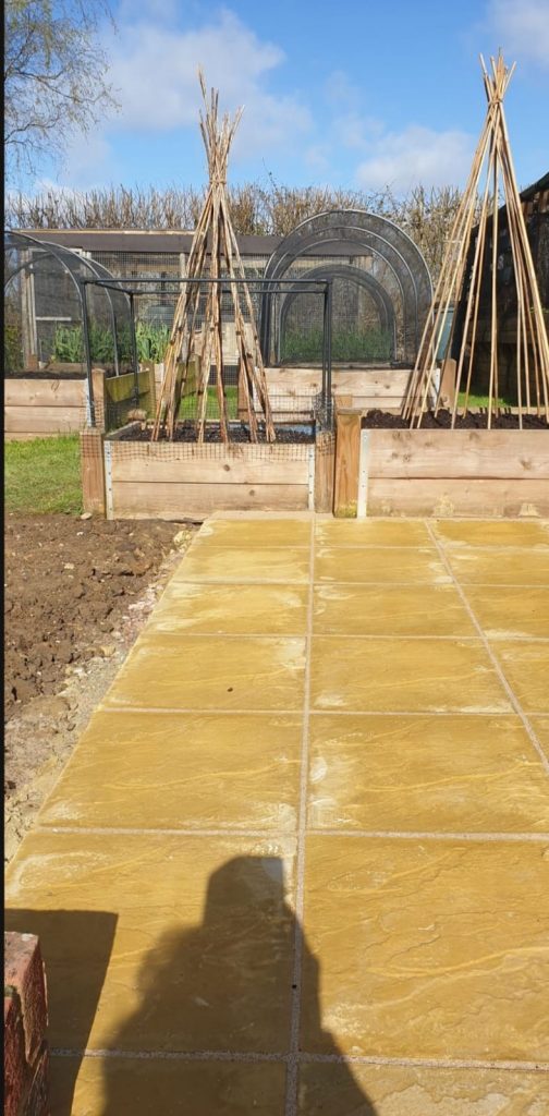 Finished-yellow-stone-patio-next-to-greenhouse-2