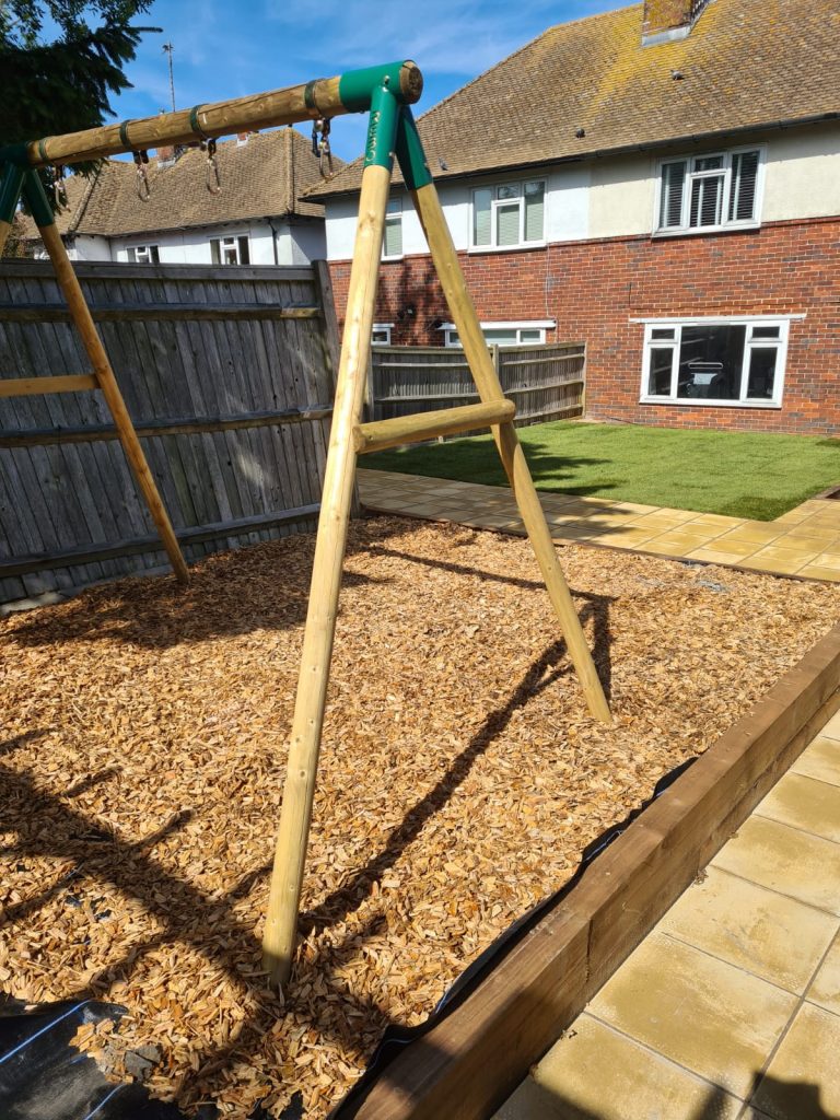 backyard-play-area-with-wood-chips-and-swing-set