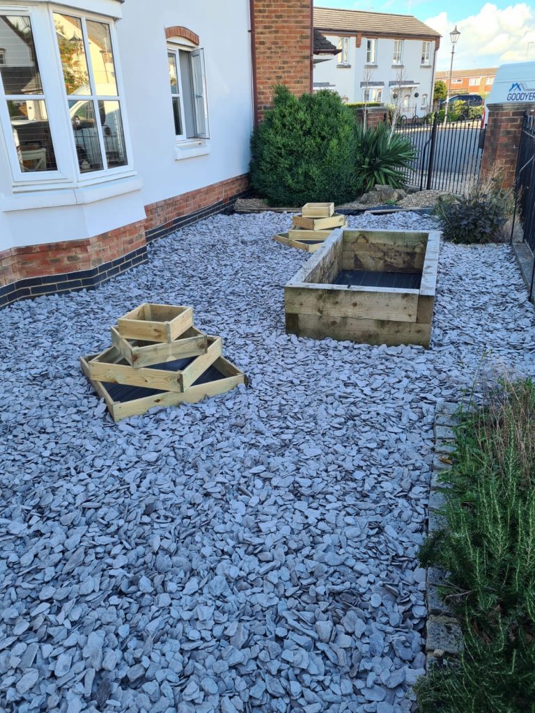 garden-with-new-wooden-planters-and-grey-slate-chippings